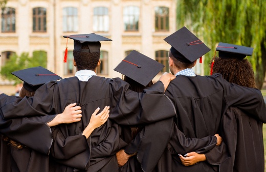 Teacher assisting high school student in class