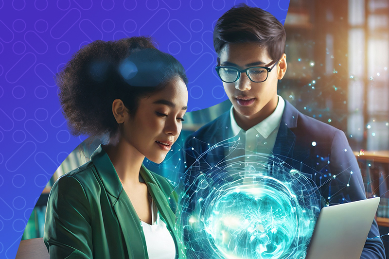 Two educators looking at a laptop.